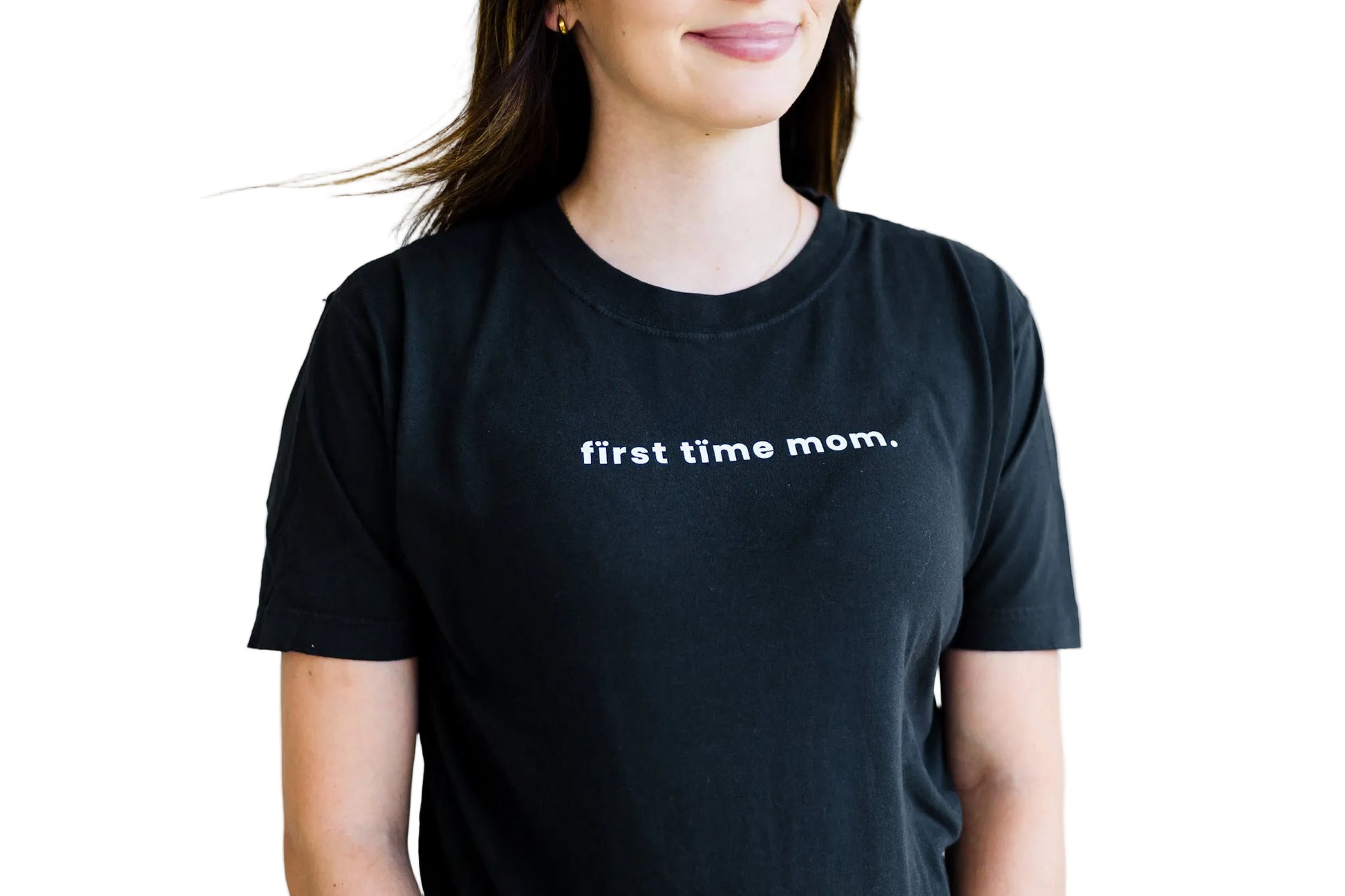 Person wearing a black t-shirt with 'first time mom' text on a plain background