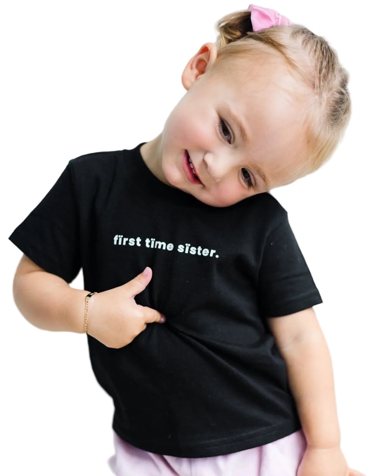 Child wearing a black t-shirt with 'first time sister' text on a white background